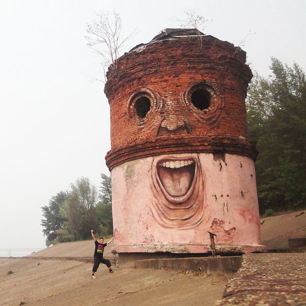 A street artist makes derelict structures come alive by adding eyes and facial features. Nikita Nomerz's work ranges from water towers painted to look like they're laughing to dilapidated buildings with broken window frames for eyes. Nomerz, from the western Russian city of Nizhniy Novgorod, travels around various cities in his homeland to carry out his art. We will have a gallery of his work on the Telegraph site later today.